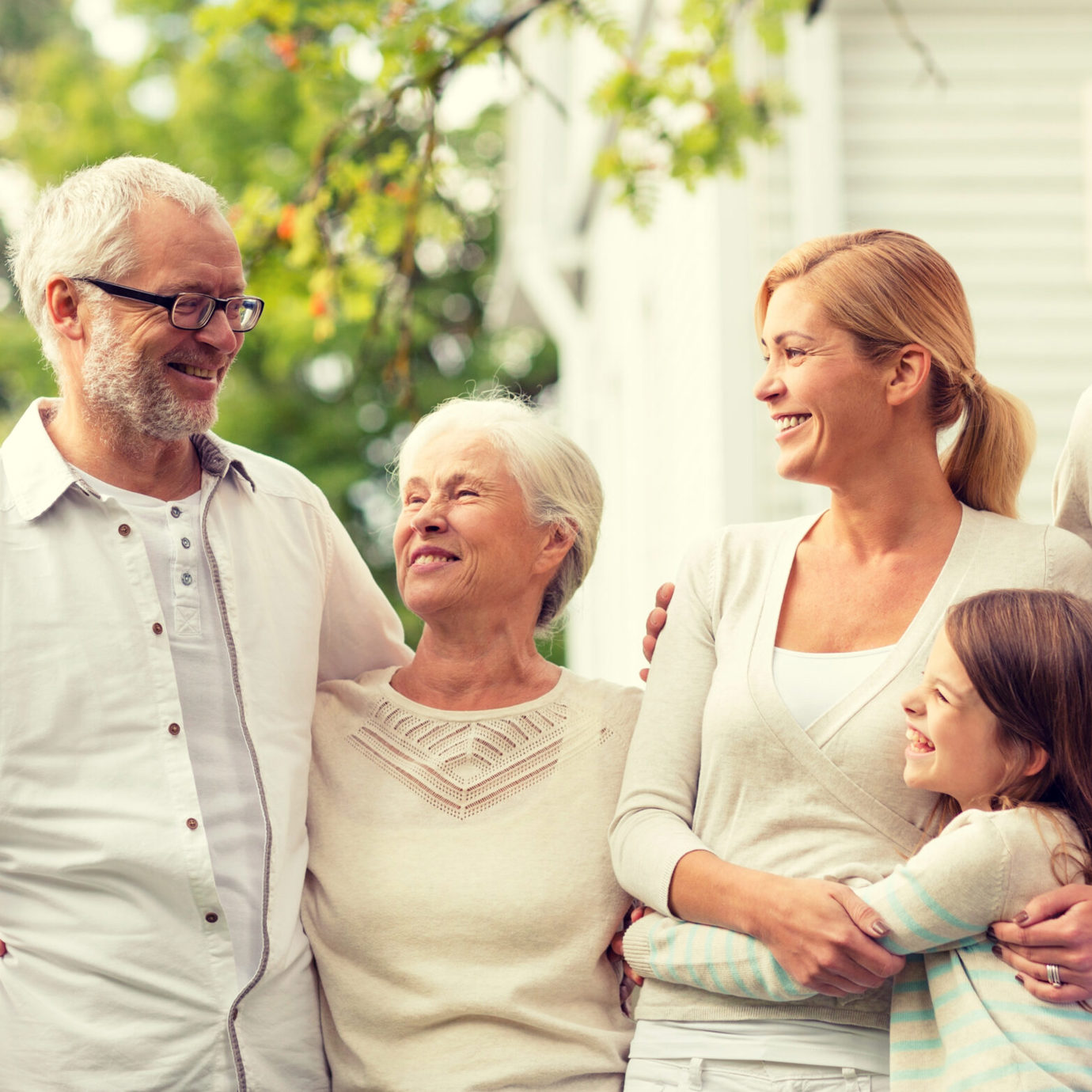 Happy multigenerational family smiling and spending time together outdoors.