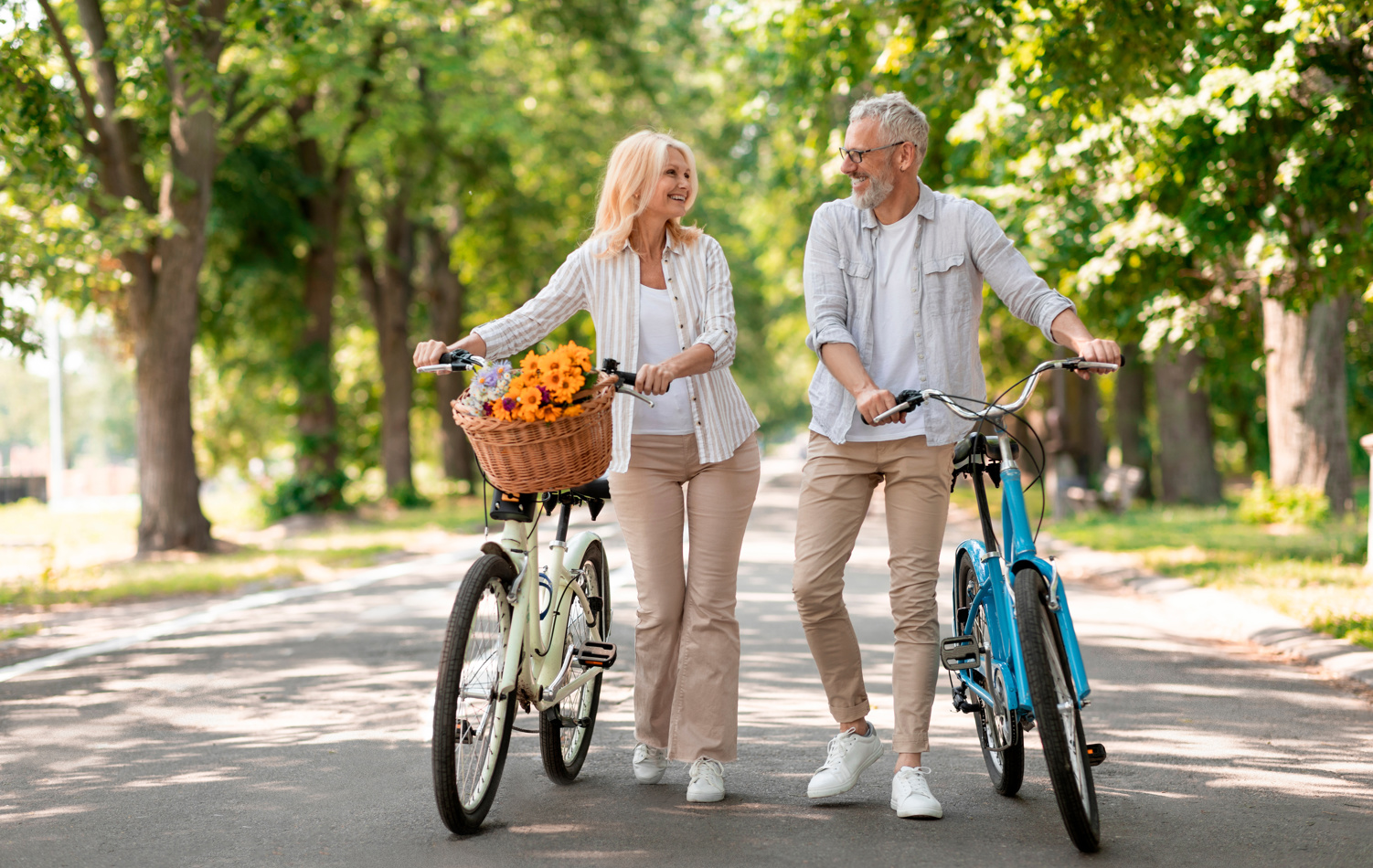 Man and a woman with bikes in the park